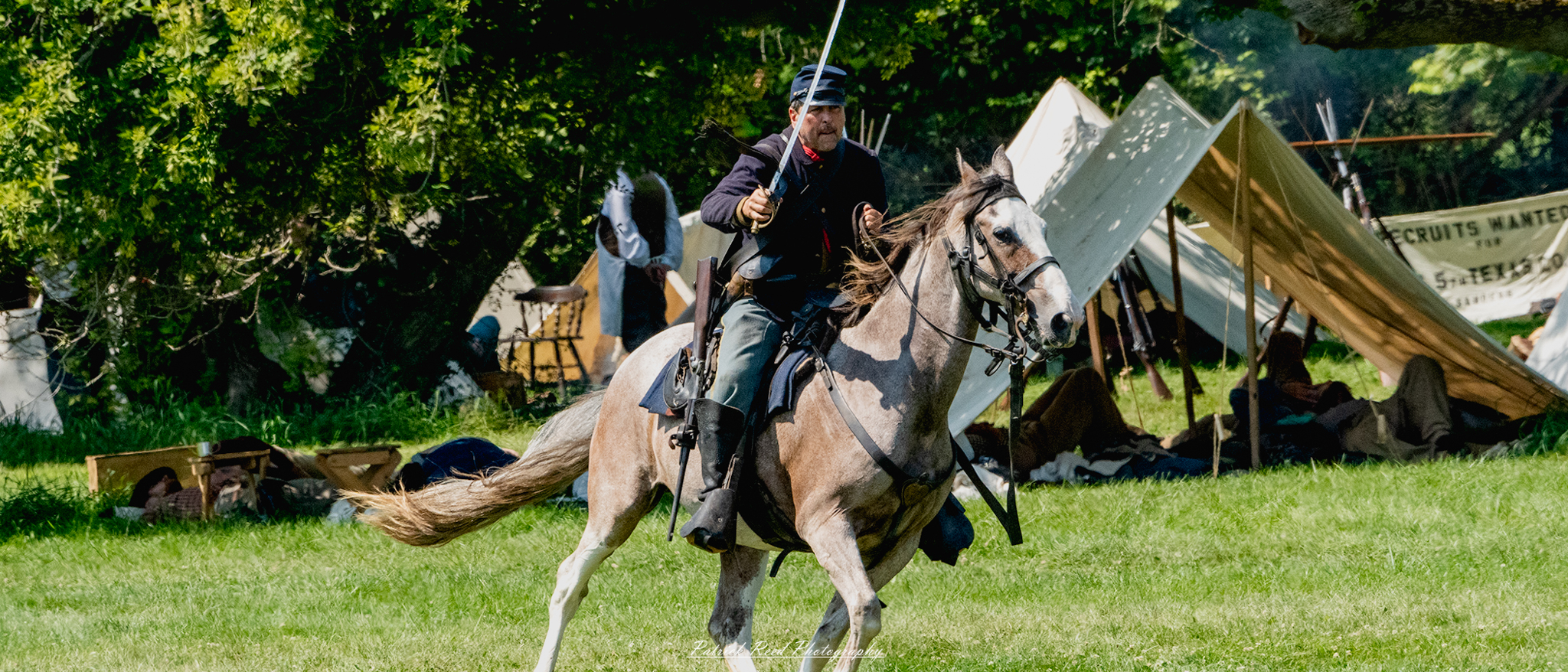 A cavalry soldier galloping on horseback, wielding a saber high in one hand while skillfully controlling the reins with the other. Dressed in a period uniform, the soldier’s expression is fierce and determined, capturing the excitement and bravery of cavalry charges during battle.